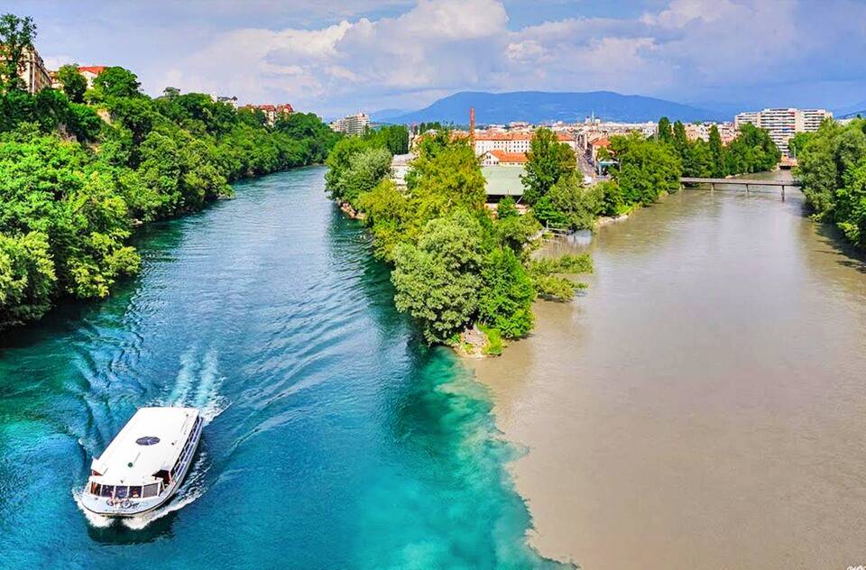 River tourism and navigation on the Rhône at the confluence of the Arve in Switzerland